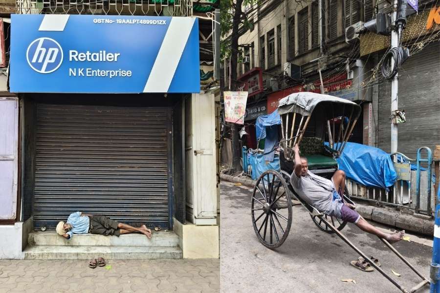 A man slept on the steps of a closed storefront, unbothered, while a hand-pulled rickshaw puller leaned back into his seat, catching a quick rest. 