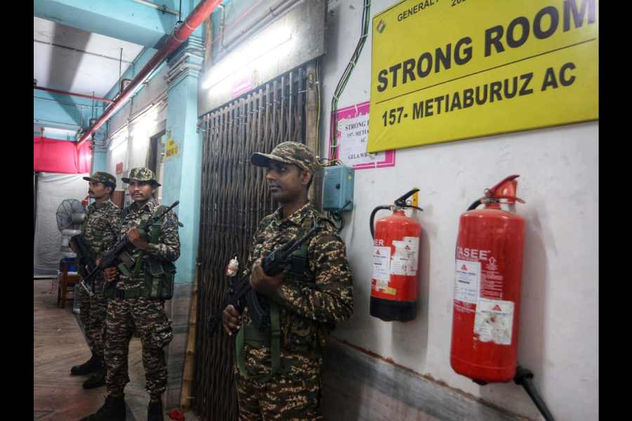 Army personnel stand guard outside a strong room in Metiaburuz.