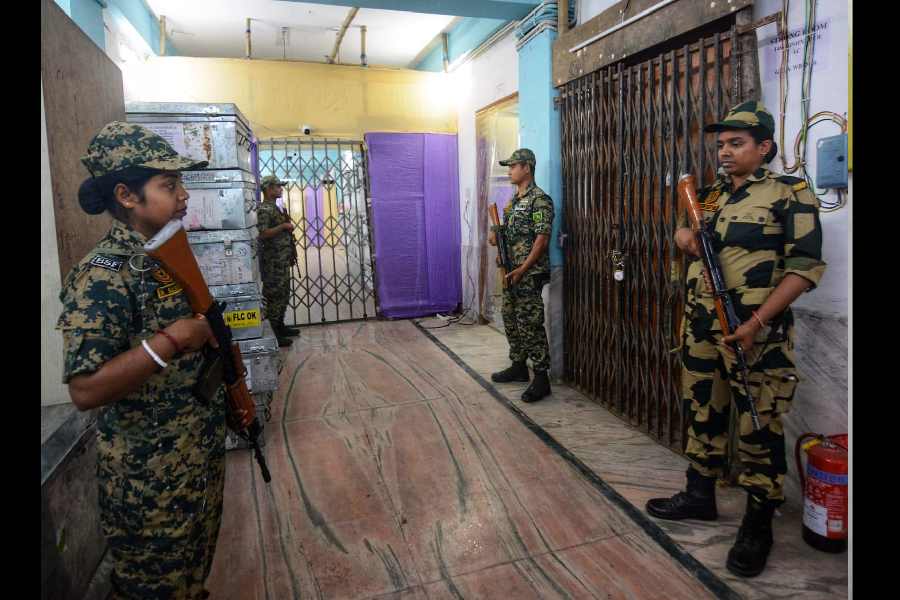 Army personnel stand guard outside a strong room in Alipur.