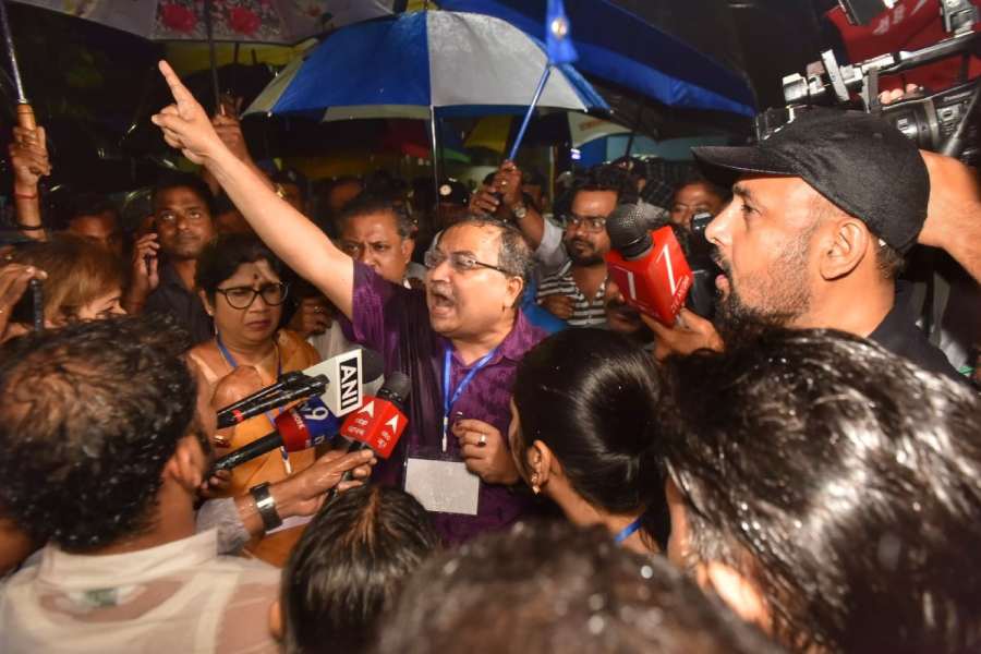 Kunal Ghosh speaks to reporters near the Netaji Indoor stadium.