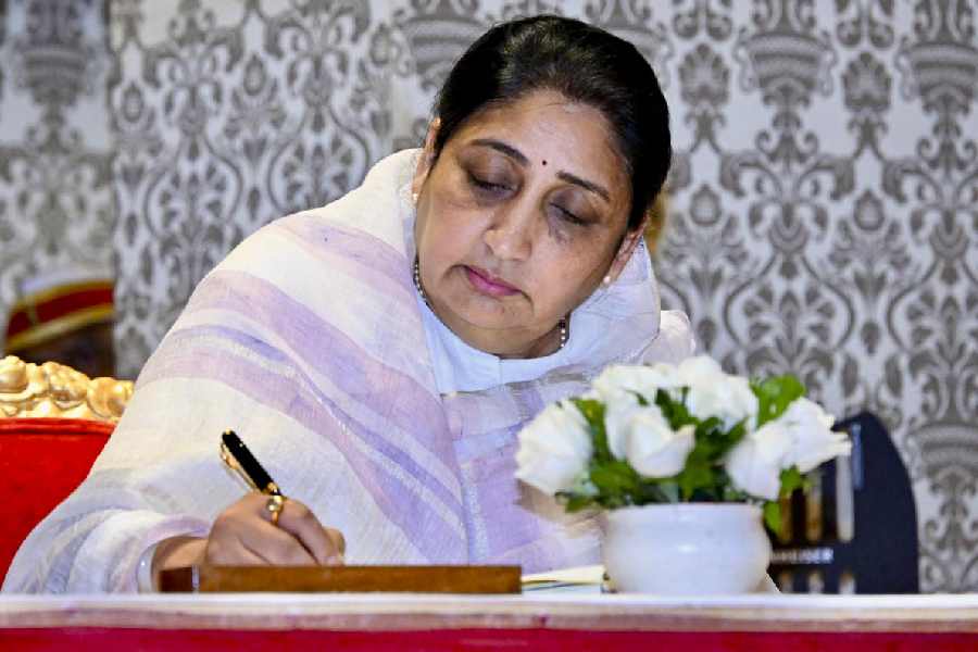 Sunetra Pawar signs documents after taking the oath as deputy chief minister on Saturday.