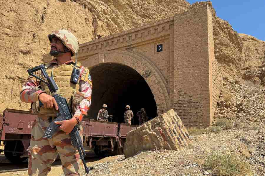 Pakistan army soldiers stand at a tunnel where the Jaffar Express train was attacked by separatist militants, in Bolan