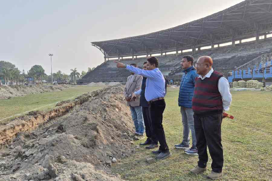 Representatives of the Sports Authority of India inspect the site where the synthetic track will be laid at the Biswa Bangla Krirangan in Jalpaiguri on Tuesday.