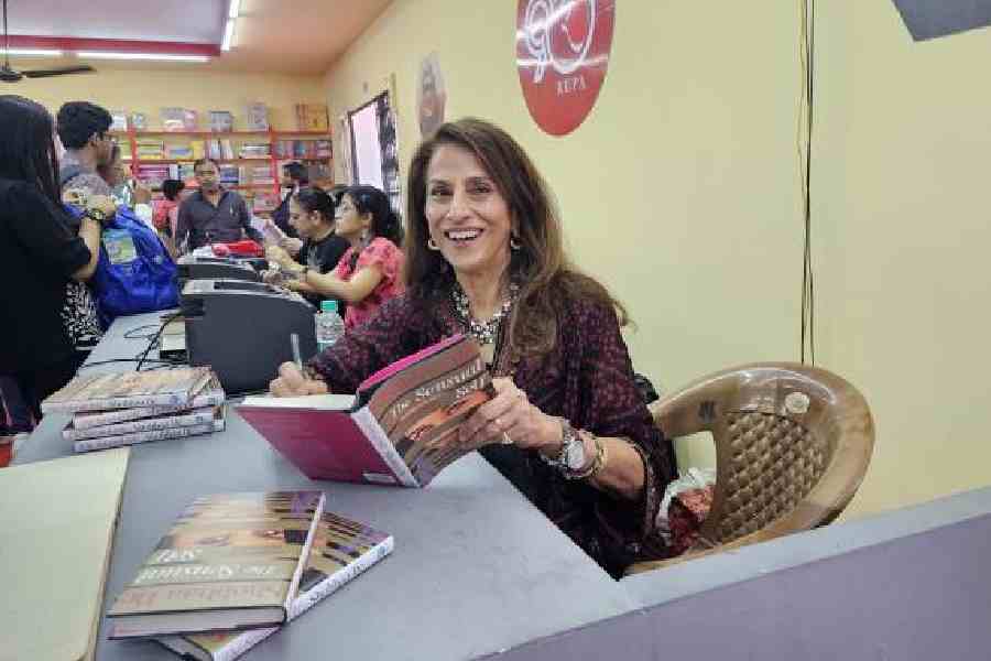 Shobhaa De signs copies of her new book The Sensual Self: Exploration of Love, Sex and Romance at the Rupa &amp; Co. stall at the International Kolkata Book Fair