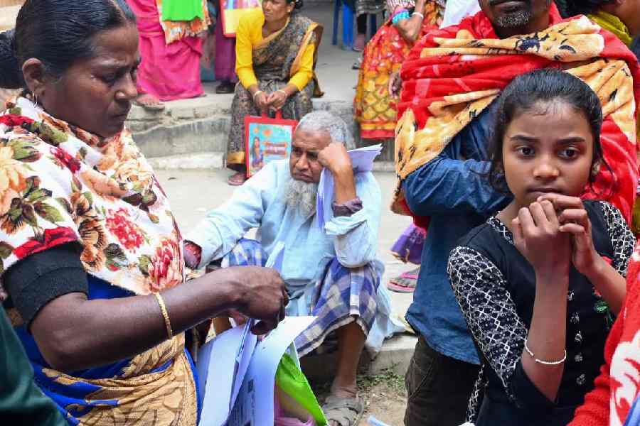 People waiting outside an SIR hearing centre in Balurghat.