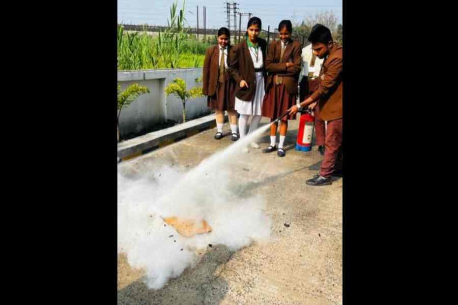 Aabir Bairagi of Julien Day School, Howrah, uses the fire extinguisher in  a mock drill 