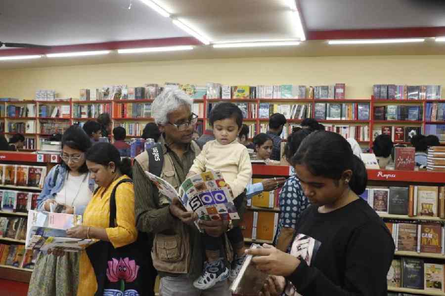 Readers engrossed in books at the 49th International Kolkata Book Fair, 2026.