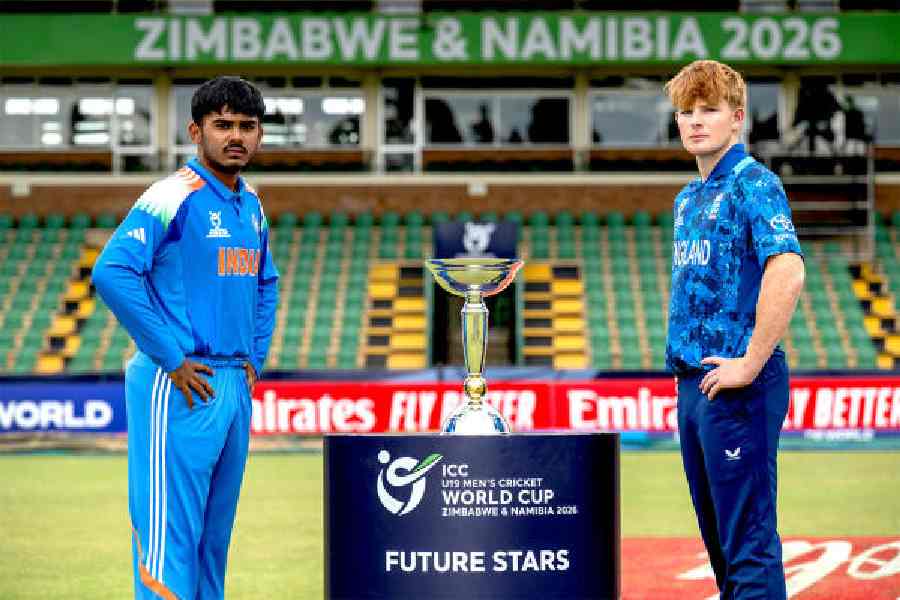 India U-19 captain Ayush Mhatre and (right) his England counterpart, Thomas Rew with the World Cup trophy up for grabs in Friday’s final match in Harare.