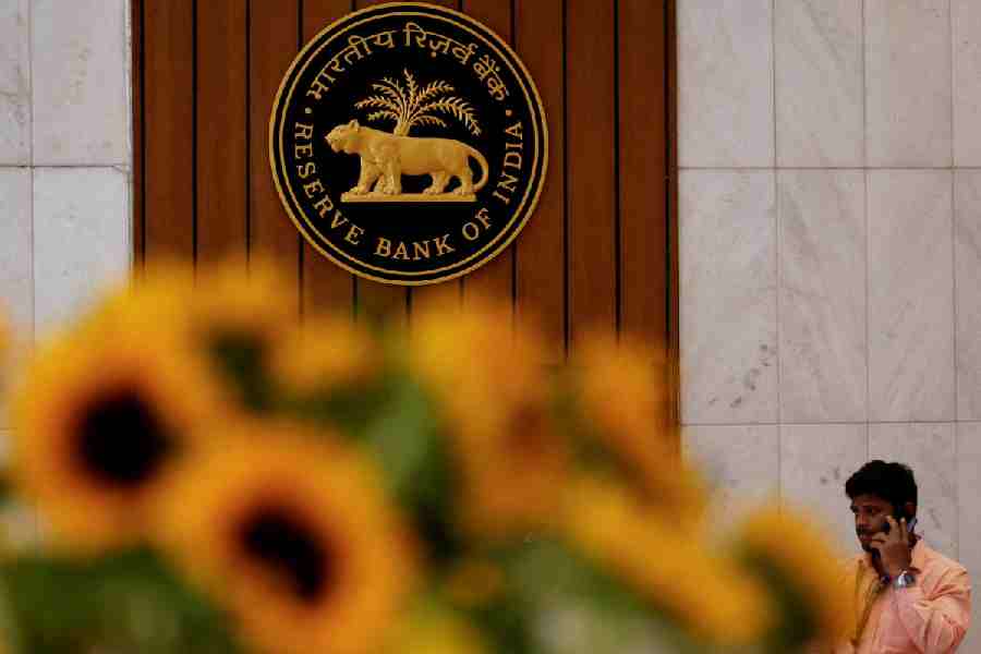 A man speaks on his phone as he walks past the Reserve Bank of India (RBI) logo inside its headquarters in Mumbai, India, February 7, 2025.