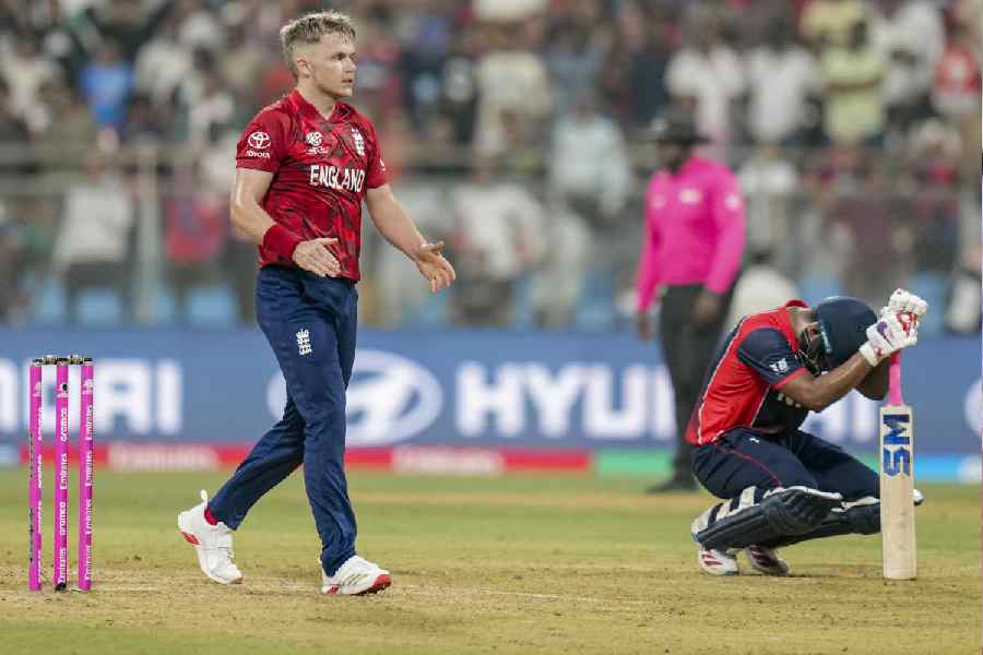 England’s Sam Curran, left, celebrates as Nepal's Lokesh Bam, right, looks dejected after the former’s team won an ICC Men's T20 World Cup 2026 cricket match between England and Nepal at the Wankhede Stadium
