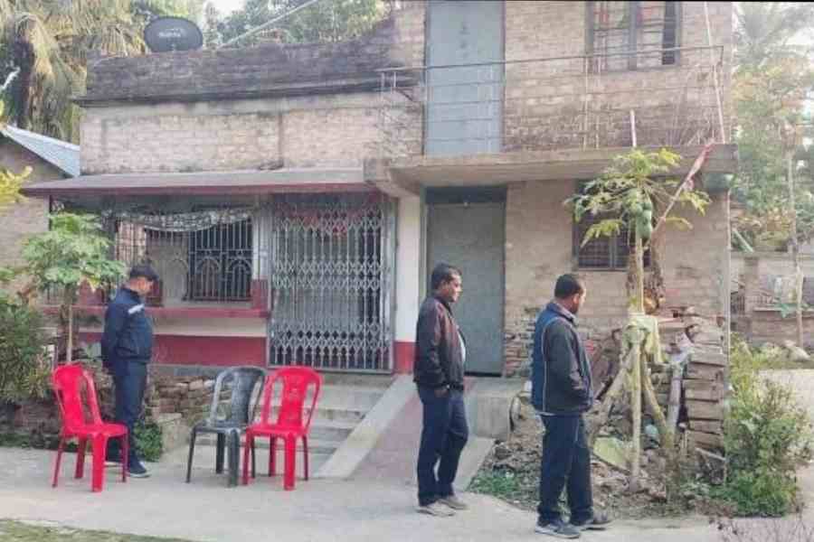Civic volunteers guard BJP worker Dipak Mondal’s residence in Ishwarigacha village in Baduria, North 24-Parganas, on Sunday afternoon. Picture by Pashupati Das