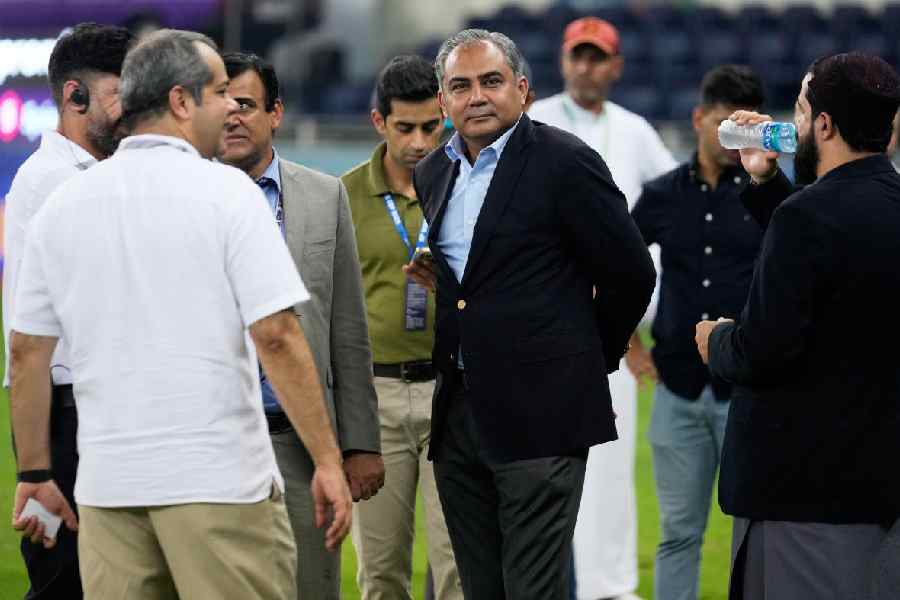 Pakistan's Minister of Interior Mohsin Naqvi, center, stands with officials on the field after India won the Asia Cup cricket final against Pakistan at Dubai International Cricket Stadium