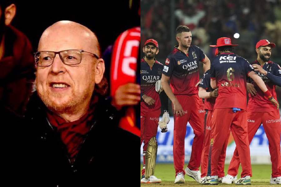 Avram Glazer (left), RCB players