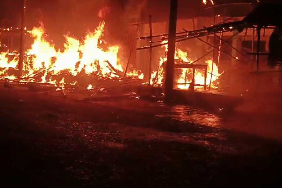 The blaze at the regulated market in Dhupguri, Jalpaiguri district, on Sunday night.