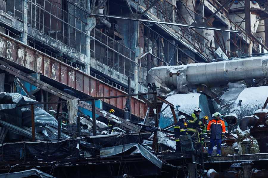 Rescuers remove debris at a thermal power plant damaged by Russian missile strikes in Ukraine
