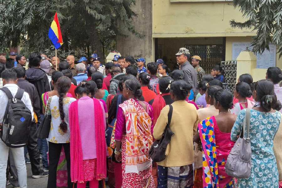Tribals under the banner of Akhil Bharatiya Adivasi Vikas Parishad protest in front of the office of the district land and land reforms officer in Jalpaiguri.