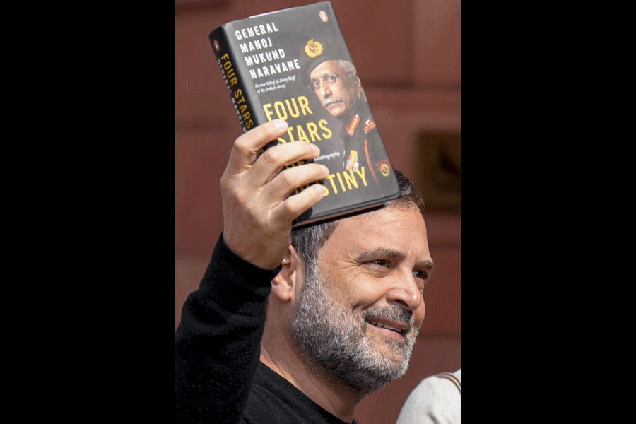 Leader of Opposition in the Lok Sabha Rahul Gandhi shows a copy of the unpublished "memoir" of former Army chief M M Naravane during the Budget Session of Parliament, in New Delhi, Wednesday, Feb. 4, 2026.