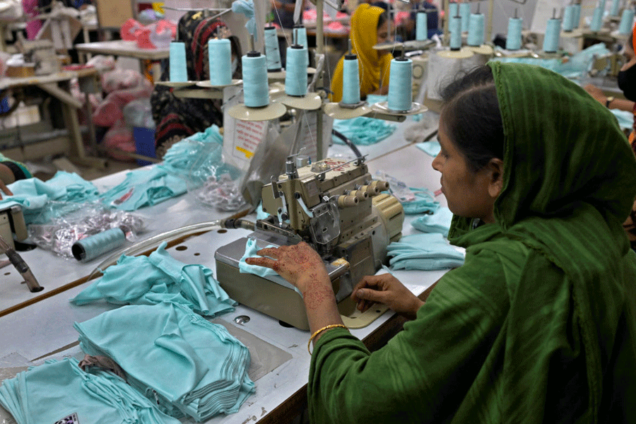 A worker sorts undergarments at the packing section of a garment factory in Ashulia