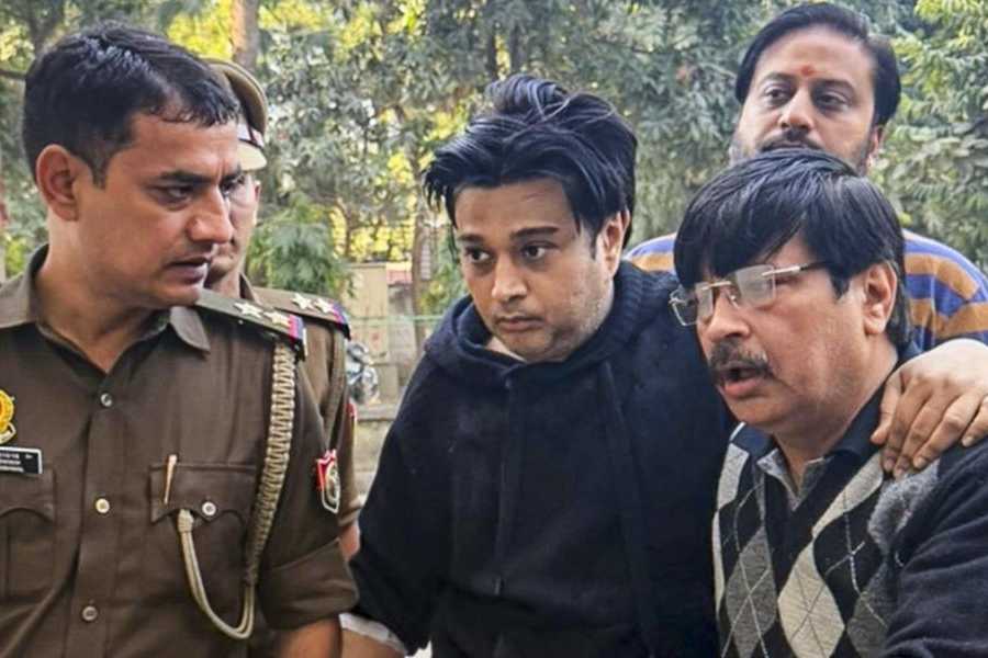 Shivam Mishra, centre, son of local tobacco baron K K Mishra, being produced at a court after his arrest in connection with the high-profile Lamborghini crash that left several people injured on the VIP Road earlier this week, in Kanpur, Thursday, Feb. 12, 2026.