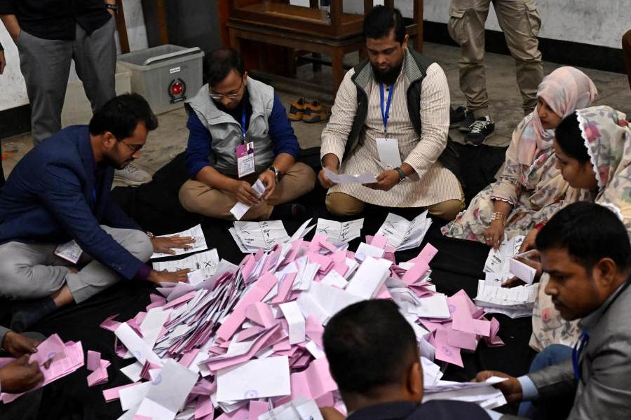Polling officials count ballots inside a counting centre during the national election in Dhaka, Bangladesh, February 12, 2026.