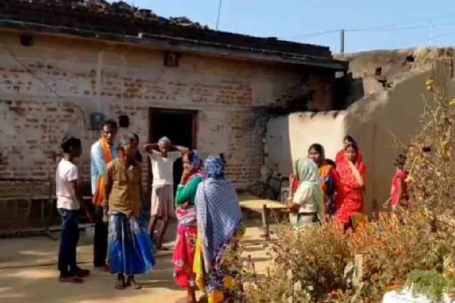 Villagers in Purulia’s Barabazaar on Thursday outside the residence of migrant worker Sukhen Mahato who was murdered in Pune on Monday. Picture Biswanath Roy