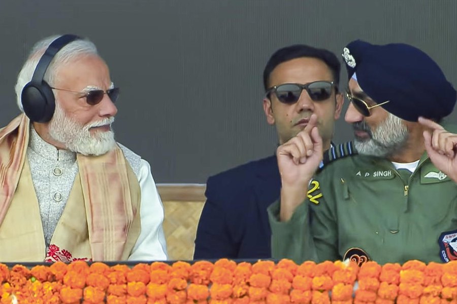 In this screenshot from a video released on Feb. 14, 2026, Prime Minister Narendra Modi with Chief of the Air Staff Air Chief Marshal Amar Preet Singh during an aerial show featuring IAF's fighter jets and transport helicopters at the Emergency Landing Facility (ELF), in Dibrugarh district, Assam.