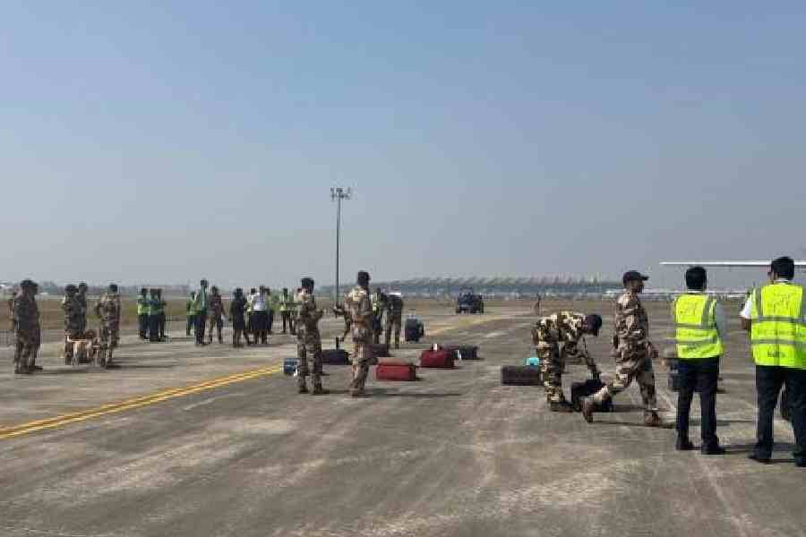 Security personnel at the Calcutta airport conduct a check after the bomb threat on Saturday morning
