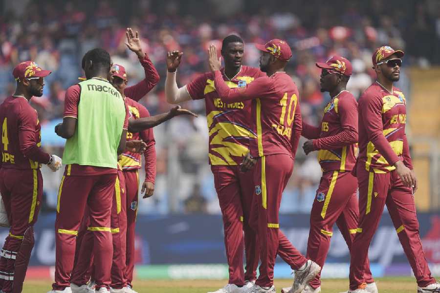 West Indies' Jason Holder, centre, celebrates with teammates after taking the wicket of Nepal's Aarif Sheikh during the ICC Men's T20 World Cup 2026 cricket match between Nepal and West Indies, at Wankhede Stadium