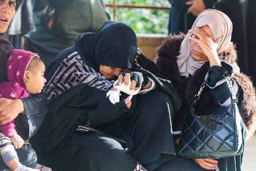 Mourners react during the funeral of Palestinians killed in an overnight Israeli strike, according to medics, at Nasser Hospital in Khan Younis in the southern Gaza Strip, February 15, 2026.