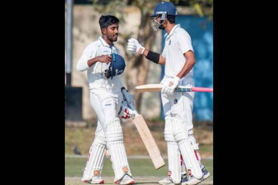 Sudip Gharami being congratulated by Shahbaz Ahmed on reaching yet another century in Kalyani on Sunday.Picture courtesy CAB