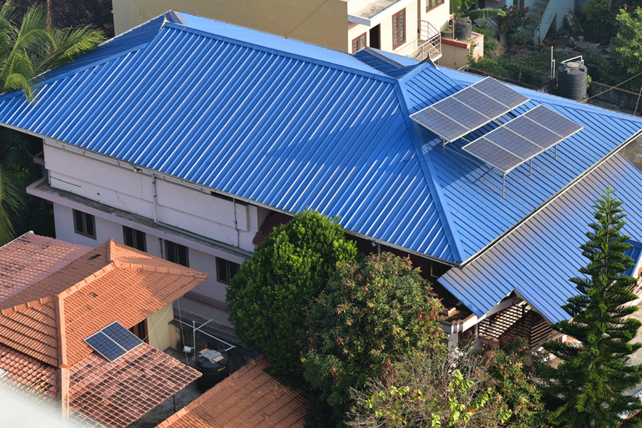 Rooftop of houses showing solar panels. Geometric shapes. View from above. Blue Aluminium roofing. Tiled roof,
