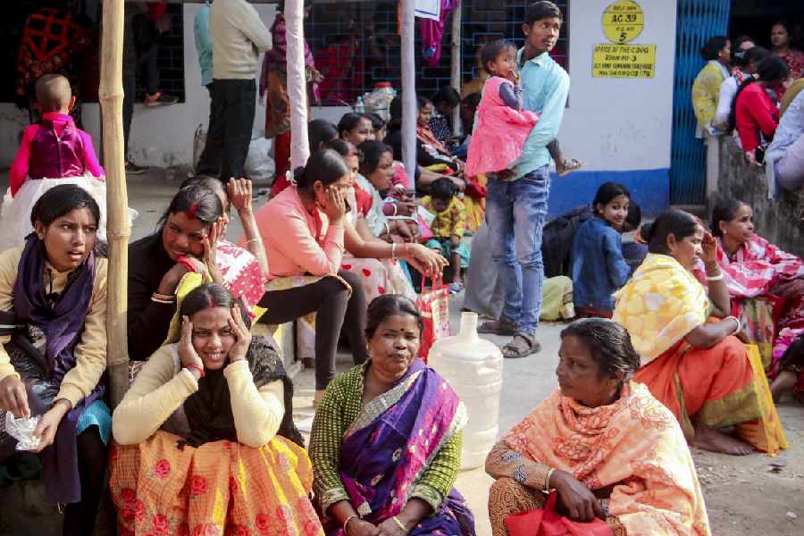 People wait for document verification during the SIR hearing in Balurghat on February 7.