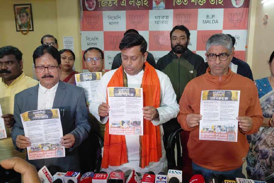 Union minister of state and Balurghat MP, with other BJP leaders, publishes the ‘charge sheets’ of the Trinamool MLAs at the district BJP office in Malda on Monday.