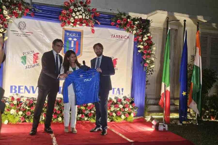 Consul general Riccardo Dalla Costa is presented with a team jersey by federation officials