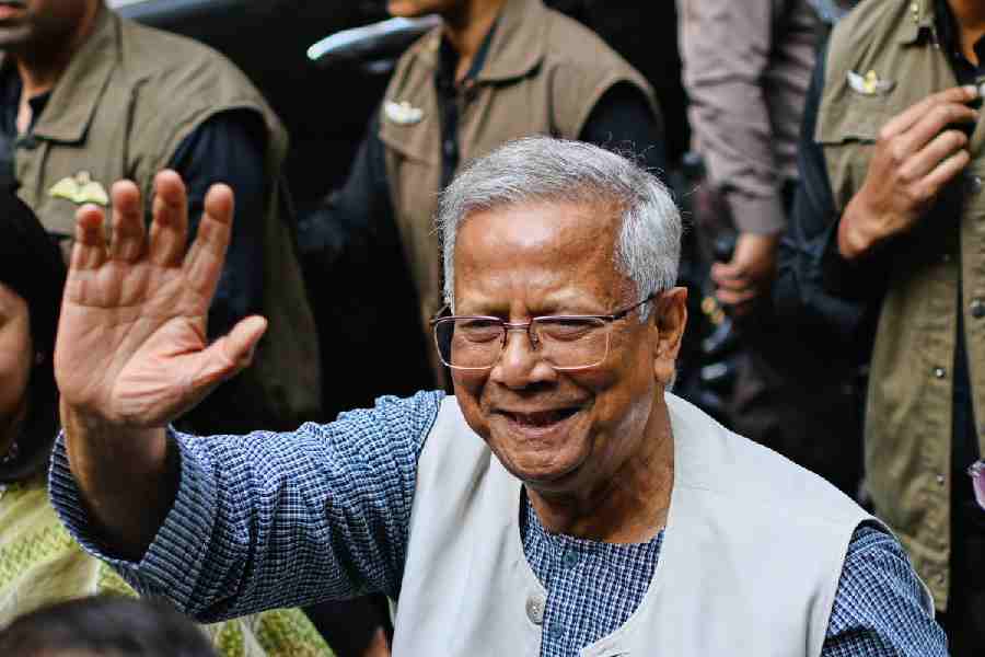 Chief Adviser of Bangladesh Muhammad Yunus waves after casting his vote as he comes out of a polling center during the national parliamentary elections in Dhaka, Bangladesh, Thursday, Feb. 12, 2026.