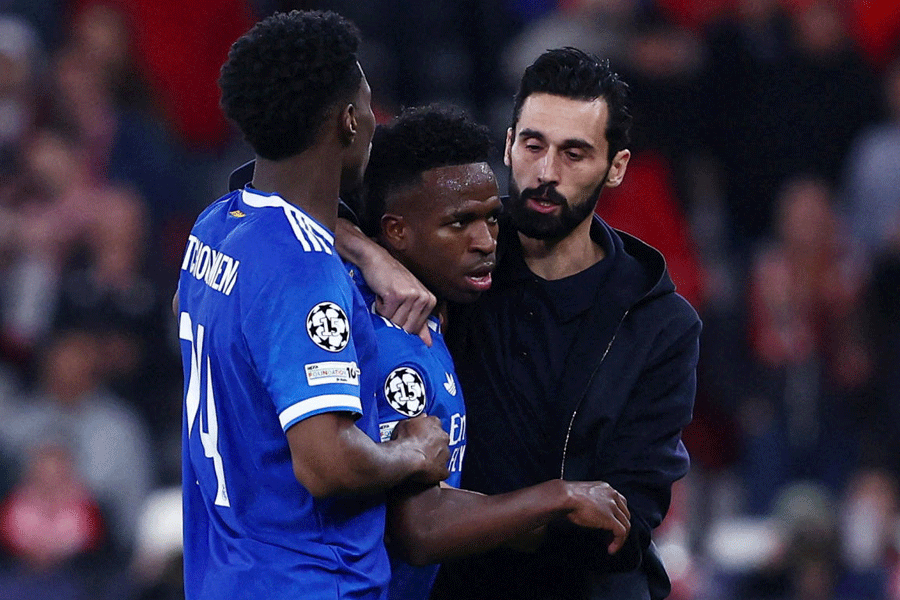 Real Madrid's Vinicius Junior with coach Alvaro Arbeloa and Aurelien Tchouameni as the match was stopped due to racist chants.