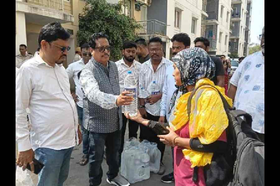 Local MLA Tapash Chatterjee distributes mineral water bottles among residents on Tuesday