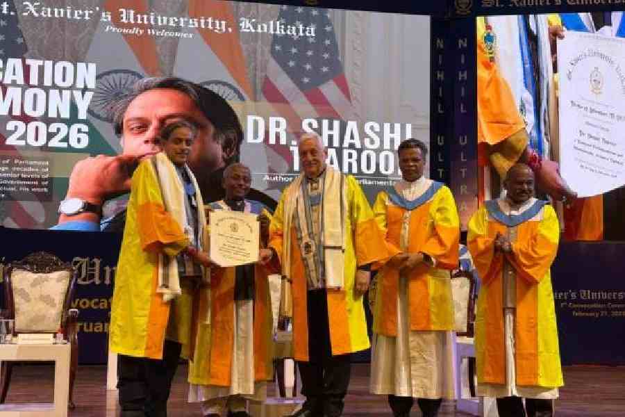 Shashi Tharoor receives an honorary doctorate from St Xavier’s University VC Father Felix Raj, while others look on, at the convocation on Saturday