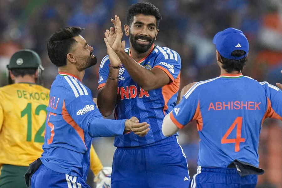 India's Jasprit Bumrah, front centre, celebrates with teammates after taking the wicket of South Africa's Quinton de Kock during an ICC Men's T20 World Cup 2026 cricket match between India and South Africa, at the Narendra Modi Stadium, in Ahmedabad, Sunday, Feb. 22, 2026.