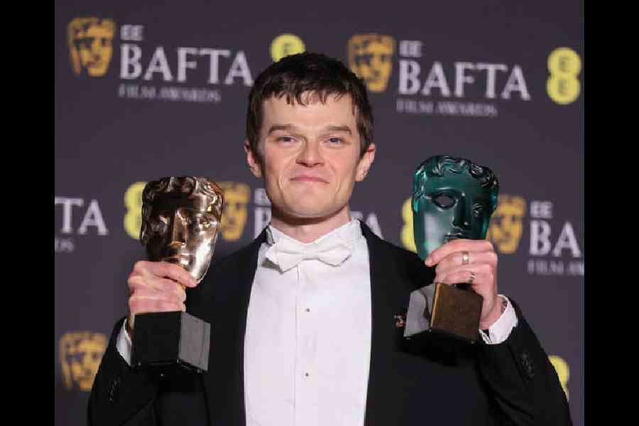 Robert Aramayo with his two BAFTAs for Best Actor for I Swear and EE Rising Star