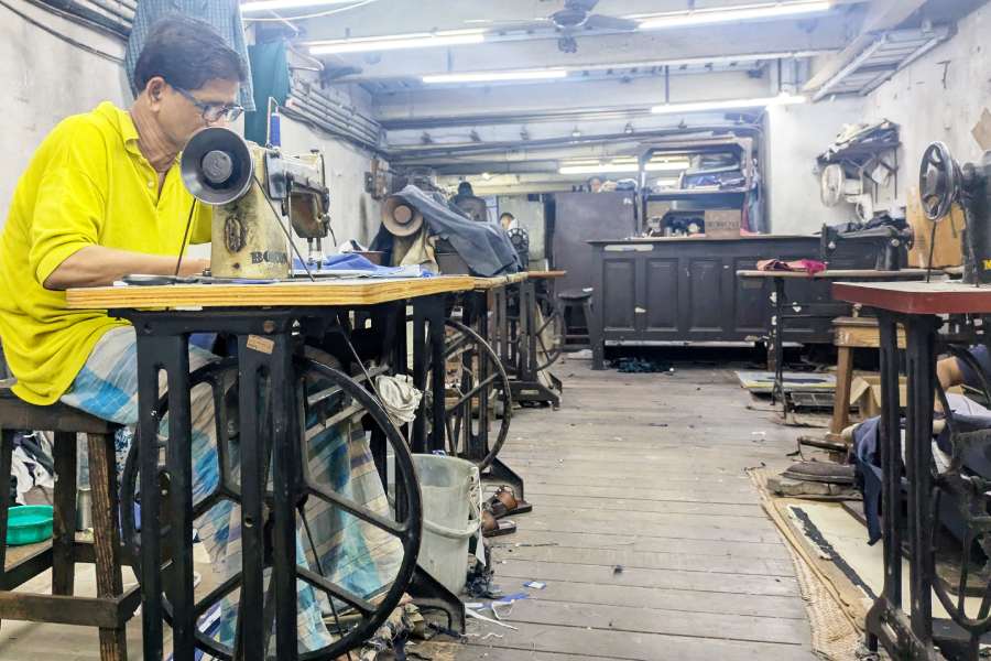 A tailor works at Barkat Ali & Brothers in Chowringhee