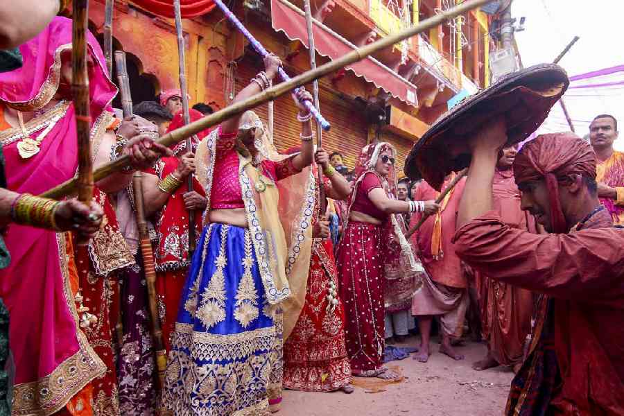 People take part in the Lathmar Holi festival celebrations, in Barsana, Mathura