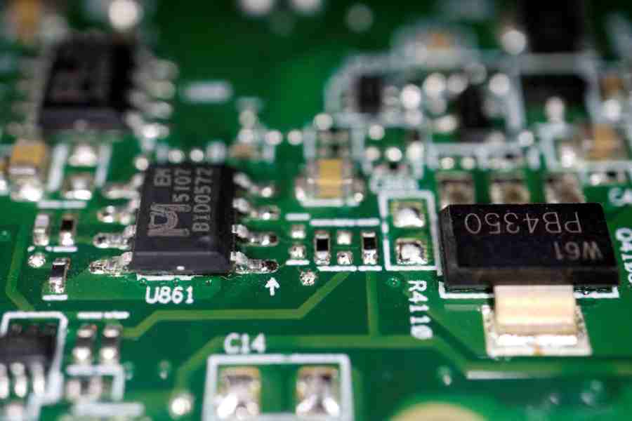 Semiconductor chips are seen on a printed circuit board in this illustration picture taken February 17, 2023.