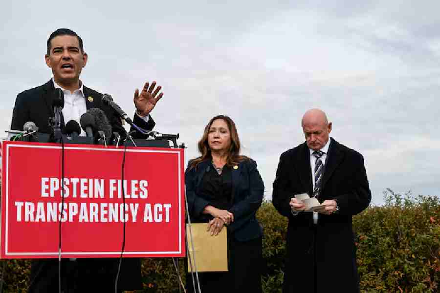 U.S. Representative Robert Garcia (D-CA) speaks next to U.S. Senator Mark Kelly (D-AZ) and U.S. Representative Adelita Grijalva (D-AZ) at a press conference calling for the release of the Epstein files, on Capitol Hill in Washington, D.C., U.S., November 18, 2025.