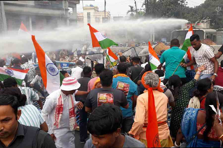 Police use the water cannon to disperse the agitators in Siliguri on Thursday. Pictures by Passang Yolmo