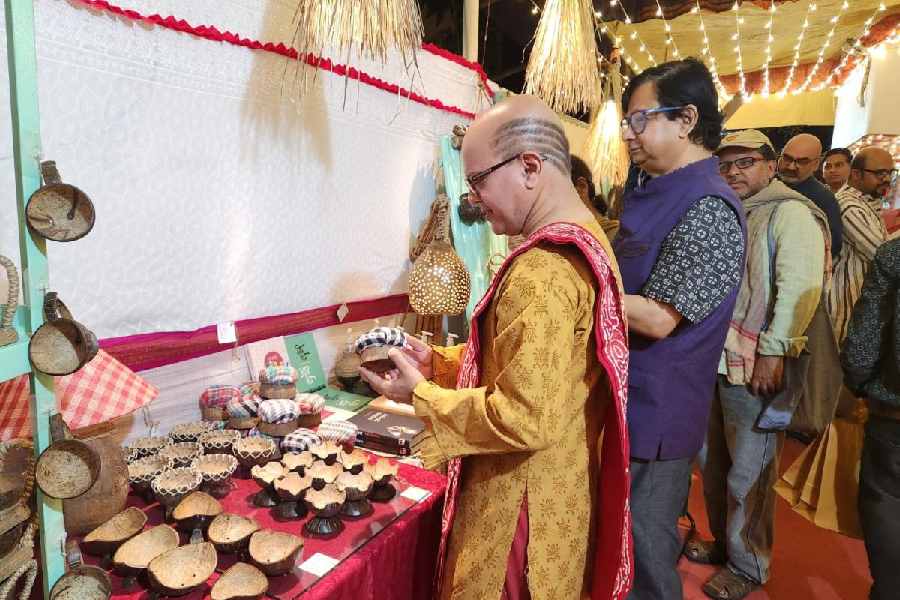 Sudarshan Chakravorty (left) and Debashis Sen check out the items at Nuttshell Handicrafts exhibition.