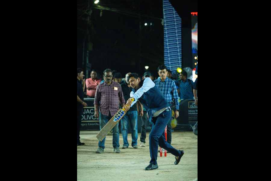 Minister Sujit Bose wields the bat during his visit