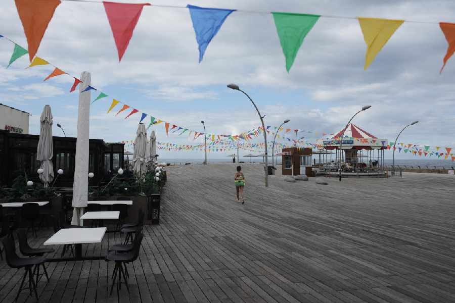 A woman runs on empty boardwalk at the Tel Aviv , Israel, port after alarms announced that Israel had launched an attack on Iran