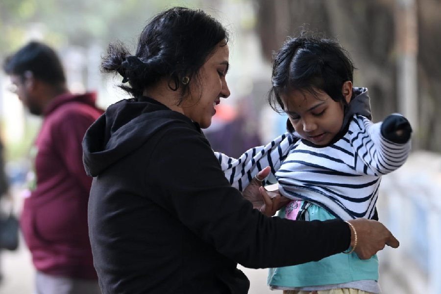 Visitors to Prinsep Ghat pull on woollens on Wednesday