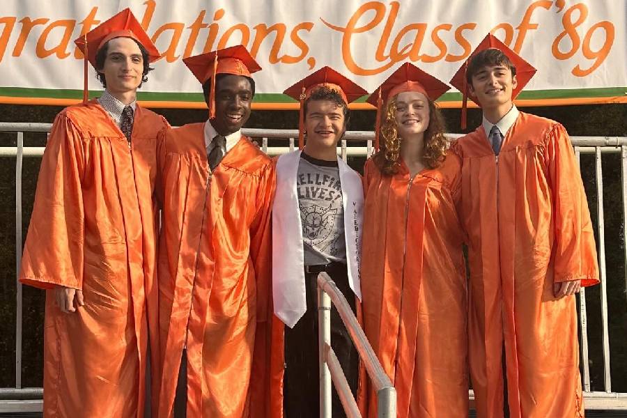 Another BTS picture shows the cast dressed in graduation robes. In the show, the Hawkins gang graduates from Hawkins High School in the finale.  